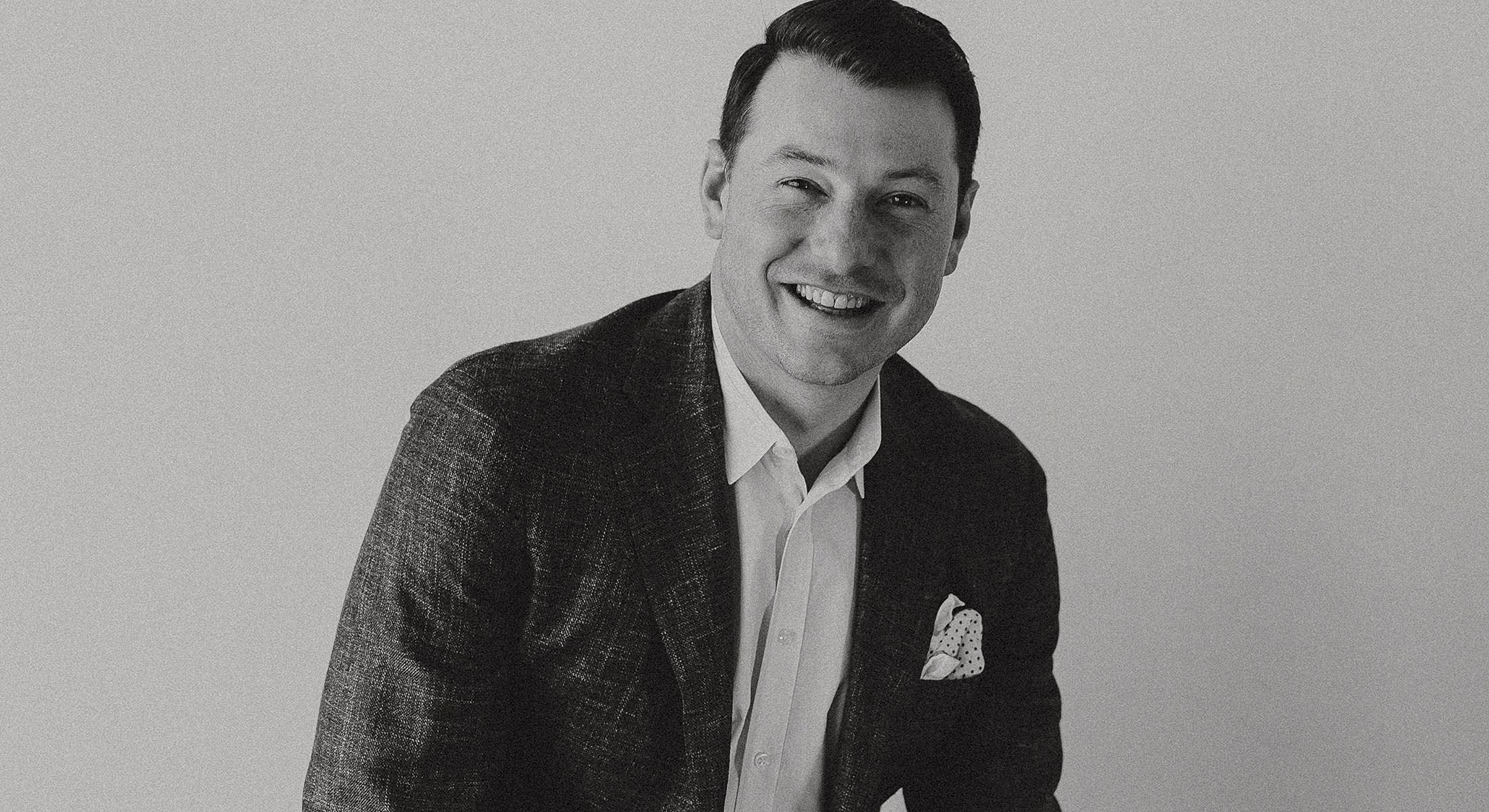 Smiling man in a stylish suit portrait.